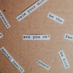 words related to mental health cut out and placed on a corkboard background