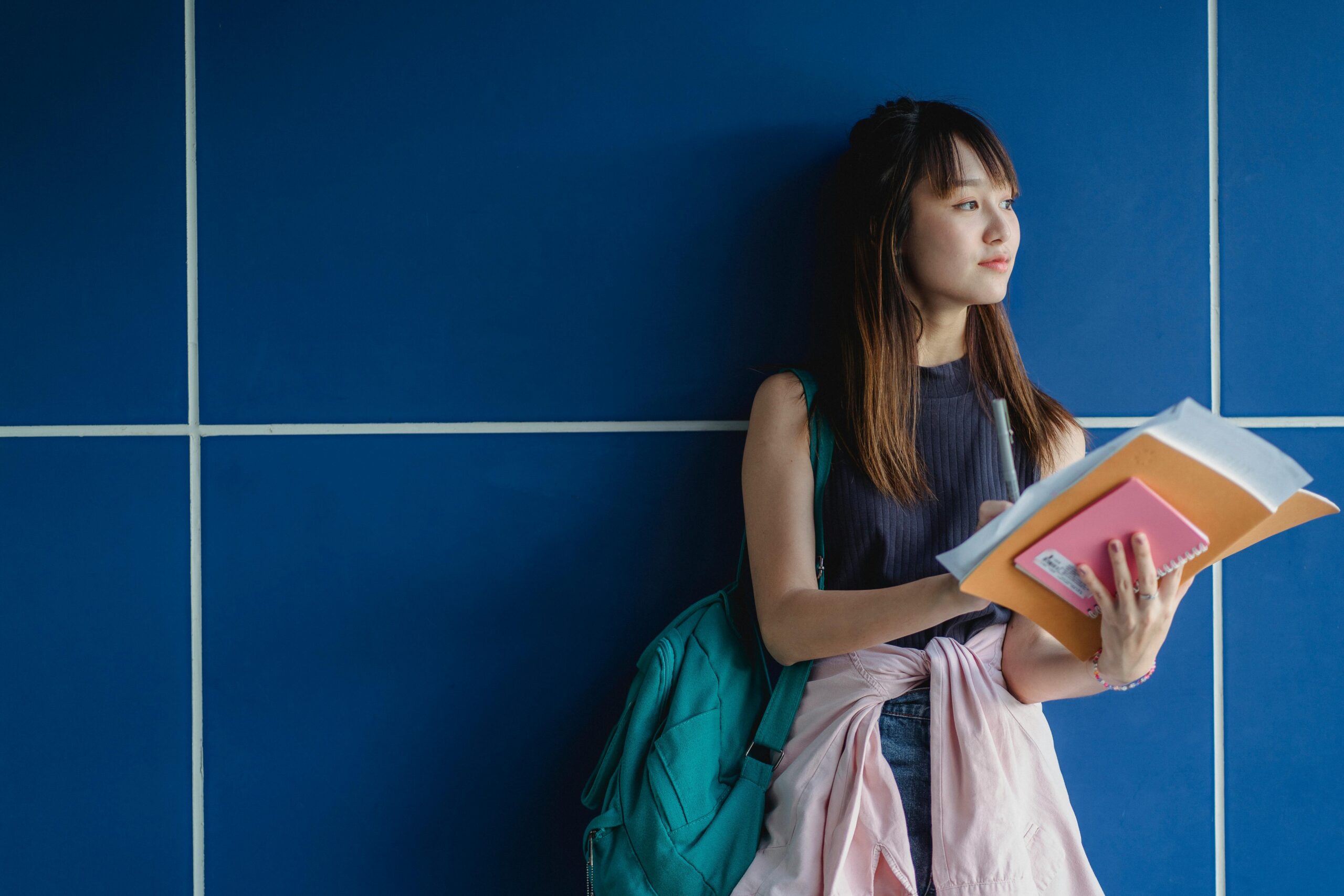 young girl holding school supplies